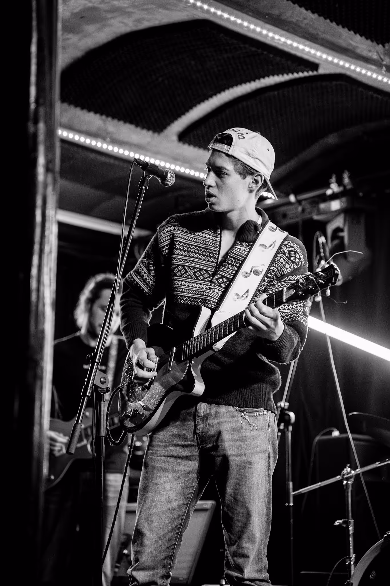 Odin S playing guitar on stage